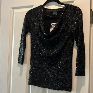 Gorgeous black top covered in sequins for the holidays. Never been worn.